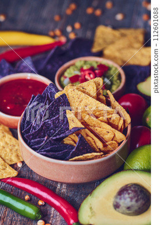 Bowl of Colorful Tortilla Chips with vegetables and other ingredients 112601088