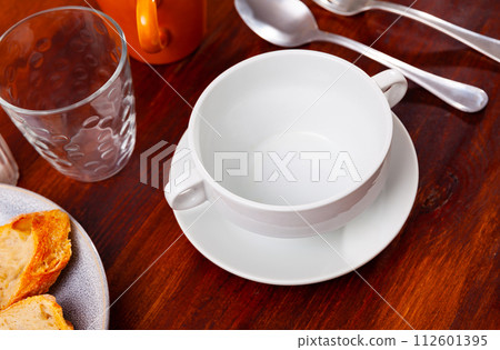 Dishes are prepared for meals on wooden table. Dishes are prepared for meals on wooden table. 112601395