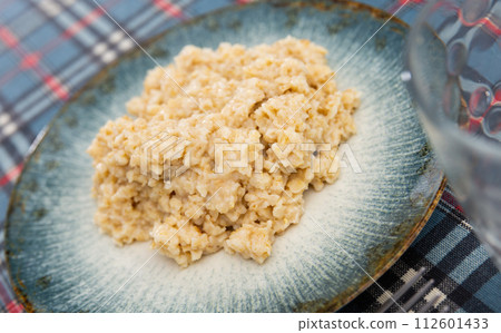 Oatmeal served on platter for breakfast 112601433