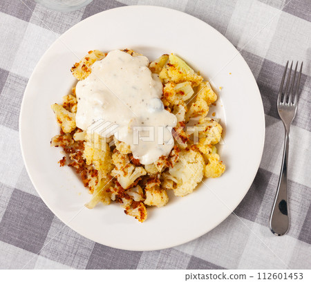Plate of delicious boiled cauliflower with spicy sauce Plate of delicious boiled cauliflower with spicy sauce 112601453