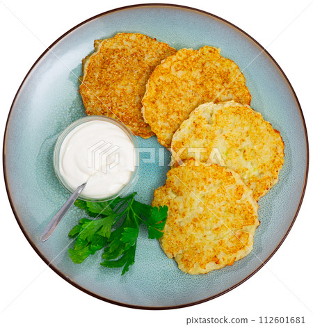 Potato pancakes served with sour cream Potato pancakes served with sour cream 112601681