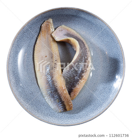 Pieces of pickled herring served on platter 112601736