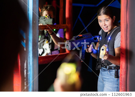 Young lady having fun playing lasertag in arena 112601963