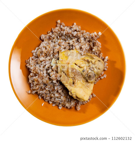 Boiled buckwheat in bowl with chicken thighs. Dinner table, healthy food concept Boiled buckwheat in bowl with chicken thighs. Dinner table, healthy food concept 112602132