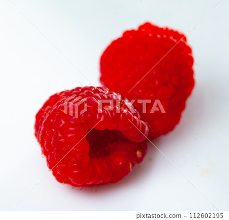 Lots of fresh sweet red raspberries arranged together representing concept of healthy diet 112602195