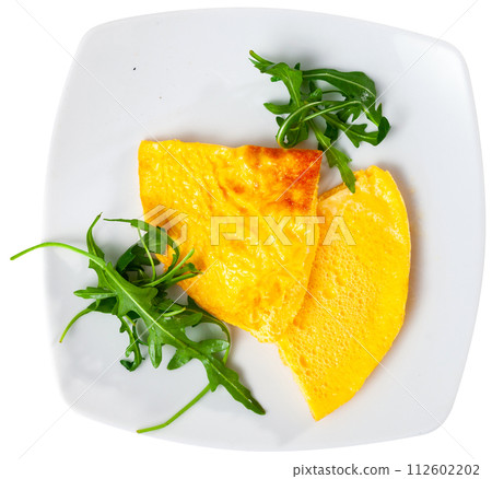 Omelette served with arugula on platter Omelette served with arugula on platter 112602202