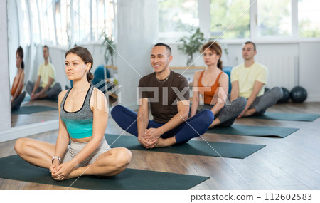 Young yogi girl making yoga meditation in lotus pose in fitness studio Young yogi girl making yoga meditation in lotus pose in fitness studio 112602583