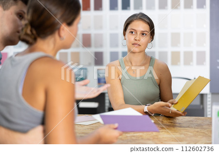 Seller of hardware store advises couple of buyer what ceramic tiles to buy Seller of hardware store advises couple of buyer what ceramic tiles to buy 112602736