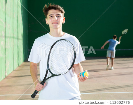 Portrait of caucasian man frontenis player in outdoor court 112602776