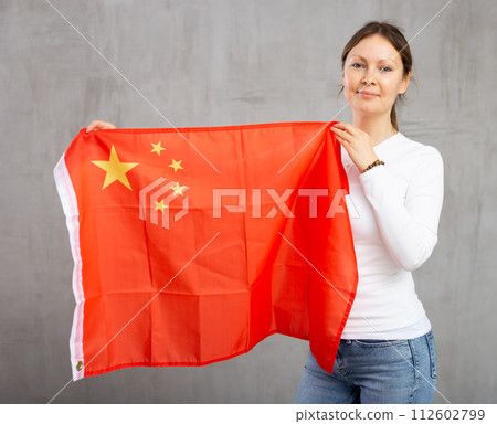 Happy woman posing with flag of China in studio Happy woman posing with flag of China in studio 112602799