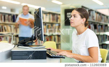 Young female European student studying with a computer Young female European student studying with a computer 112603069