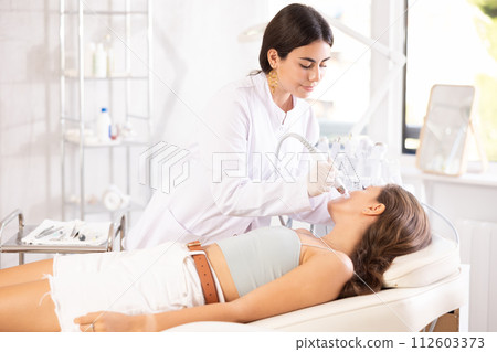 female aesthetician making facial skin cleaning female aesthetician making facial skin cleaning 112603373