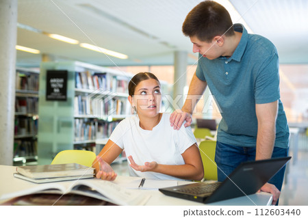 View on a young European man teaching a female Caucasian student View on a young European man teaching a female Caucasian student 112603440