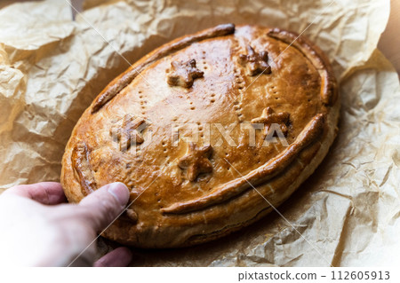 homemade pie with nuts and honey on baking paper 112605913