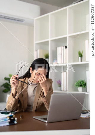 Eco friendly, businesswoman young asian stress in working on laptop while sitting at home office 112607357