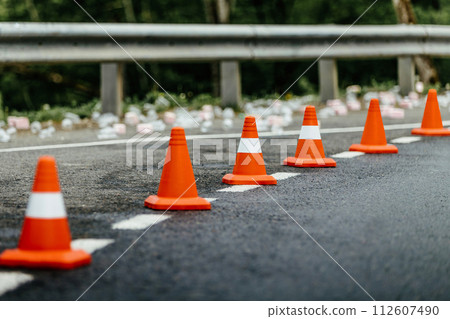 six orange traffic cones standing in row on mountain road six orange traffic cones standing in row on mountain road 112607490