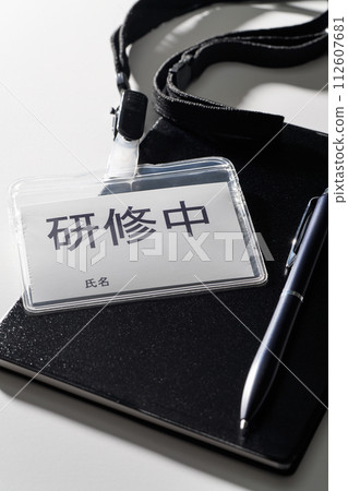 A name tag that says “In training” A name tag that says “In training” 112607681