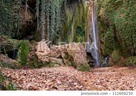 Waterfall in the autumn forest. Autumn forest waterfall. Autumn waterfall in autumn forest. Waterfall landscape. High quality photo 112608250