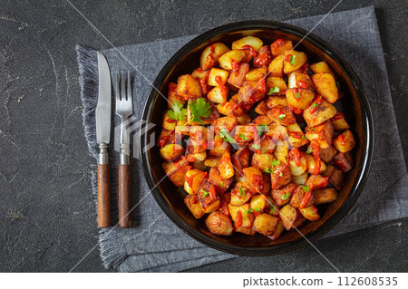 fried spanish potatoes with paprika sauce in bowl 112608535