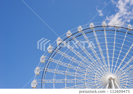 Part of ferris wheel in white color against summer blue sky Part of ferris wheel in white color against summer blue sky 112609475