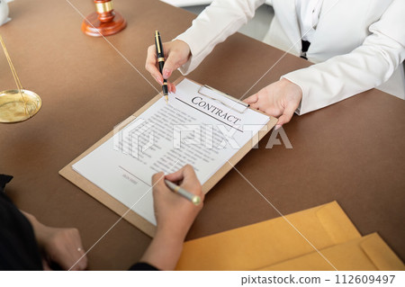 Lawyer office the company hired the lawyer office a legal advisor and draft the contract so that the client could signs contract. Contract of sale was on the table in the lawyer office  112609497