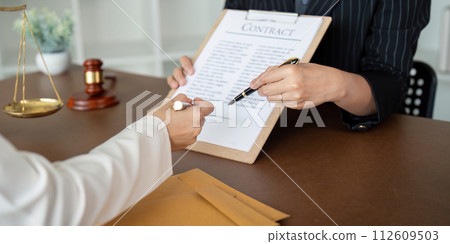 Lawyer office the company hired the lawyer office a legal advisor and draft the contract so that the client could signs contract. Contract of sale was on the table in the lawyer office Lawyer office the company hired the lawyer office a legal advisor and draft the contract so that the client could signs contract. Contract of sale was on the table in the lawyer office 112609503