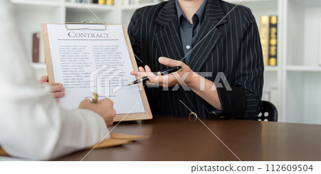 Lawyer office the company hired the lawyer office a legal advisor and draft the contract so that the client could signs contract. Contract of sale was on the table in the lawyer office Lawyer office the company hired the lawyer office a legal advisor and draft the contract so that the client could signs contract. Contract of sale was on the table in the lawyer office 112609504