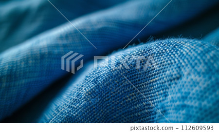 Textured blue fabric with intricate woven patterns creating a cozy and warm atmosphere. Textured blue fabric with intricate woven patterns creating a cozy and warm atmosphere. 112609593