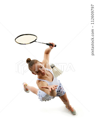 Top view dynamic image of young girl in uniform playing badminton, training isolated over white background 112609797
