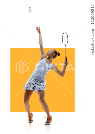 Sportive young girl, badminton player in motion serving shuttlecock with racket isolated over white background with yellow element 112609813