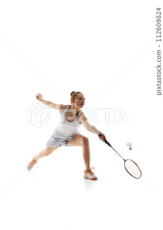 Concentrated young girl, athlete in motion with racket, playing badminton isolated over white background 112609824