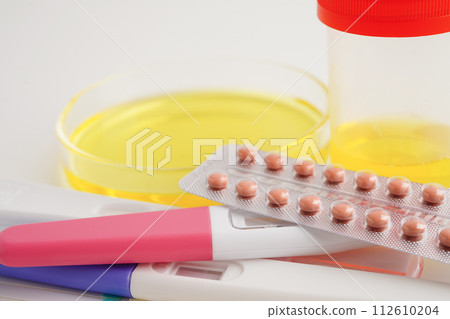 Urinalysis, pregnancy test and urine cup for female of ovulation day, fetus, maternity, childbirth, birth control. 112610204