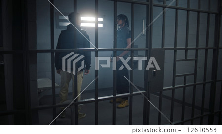 Multi ethnic teen prisoners fight in prison cell 112610553