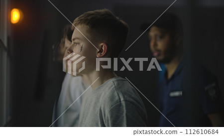 African American jailer talks to diverse young prisoners African American jailer talks to diverse young prisoners 112610684