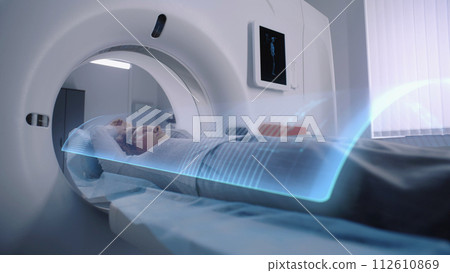 Woman undergoes MRI or CT scan diagnostic. VFX animation of scanning 112610869