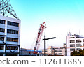 Heavy equipment at the construction site and surrounding buildings 112611885