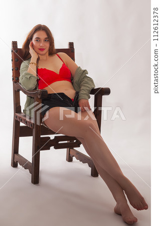 Seductive charisma: self-confident woman in red lingerie and blouse Seductive charisma: self-confident woman in red lingerie and blouse 112612378