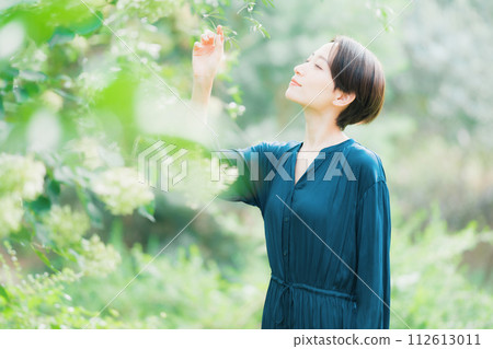 A woman relaxing in the garden 112613011