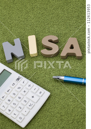 NISA letter block placed on a green carpet NISA letter block placed on a green carpet 112613953