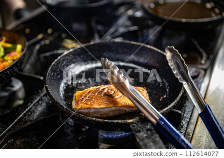 Duck breast cooking on a hot pan 112614077