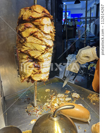 Photograph a street vendor skillfully making delicious snack shawarma Photograph a street vendor skillfully making delicious snack shawarma 112614267
