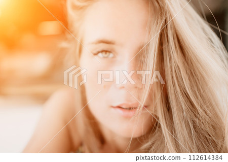 Happy woman portrait in cafe. Boho chic fashion style. Outdoor photo of young happy woman with long hair, sunny weather outdoors sitting in modern cafe. 112614384