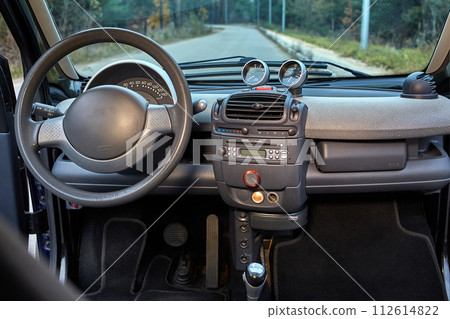Shift lever, car steering wheel and sensors. Inside a modern car view, city car interior background 112614822