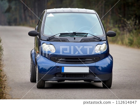Little blue car driving on the road,  modern city car background 112614847