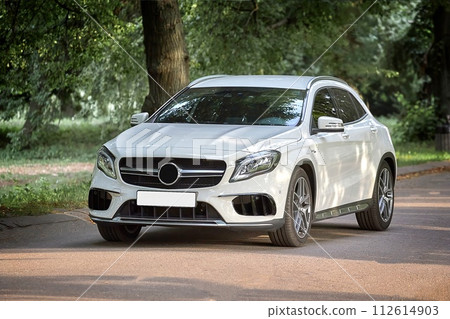 Modern white car driving in the country side background, luxury city car wallpaper Modern white car driving in the country side background, luxury city car wallpaper 112614903