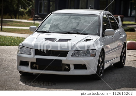 White car on a street background. Modern city sport car with a spoiler wallpaper White car on a street background. Modern city sport car with a spoiler wallpaper 112615262