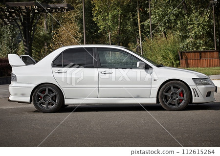 White car on a street background. Modern city sport car with a spoiler wallpaper White car on a street background. Modern city sport car with a spoiler wallpaper 112615264