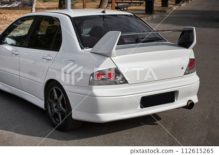 White car on a street background. Modern city sport car with a spoiler wallpaper White car on a street background. Modern city sport car with a spoiler wallpaper 112615265