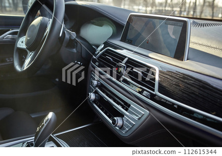 Shift lever, car steering wheel and sensors. Inside a modern car view, city car interior background 112615344