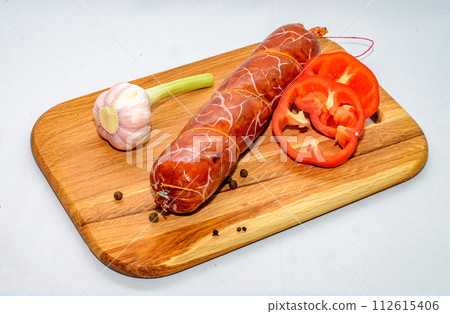 Tasty sausages and vegetables isolated over solid background Tasty sausages and vegetables isolated over solid background 112615406